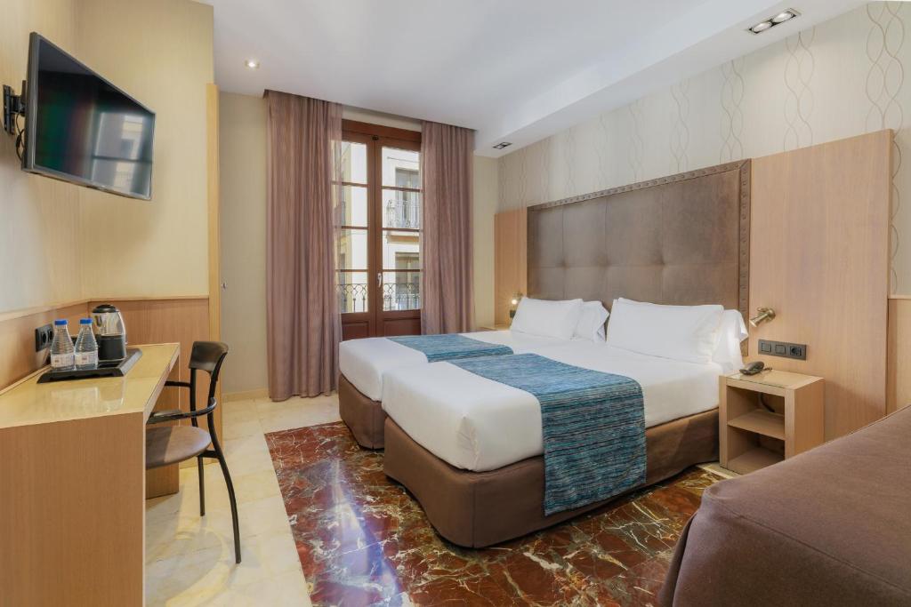 Posteľ alebo postele v izbe v ubytovaní Hotel Gótico