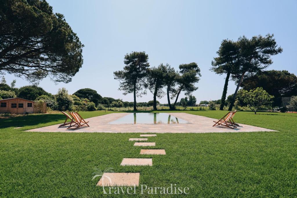 a park with benches on a grass field at Villa du Golf in Les Portes