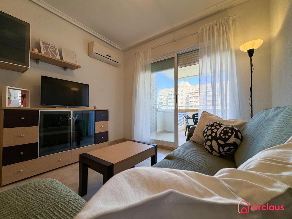a living room with a couch and a tv at Rincón Ideal in Oropesa del Mar