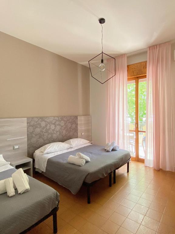 Postel nebo postele na pokoji v ubytování Hotel Residence Ponente