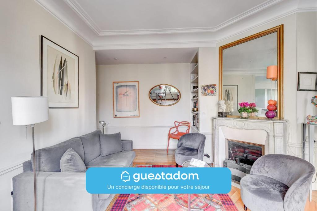 - un salon avec un canapé, des chaises et une cheminée dans l'établissement Lecourbe - Wifi - 15ème arrondissement, à Paris