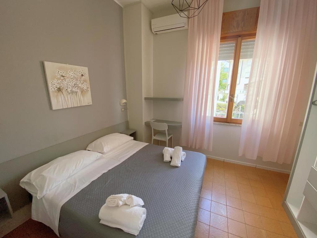 Postel nebo postele na pokoji v ubytování Hotel Residence Ponente
