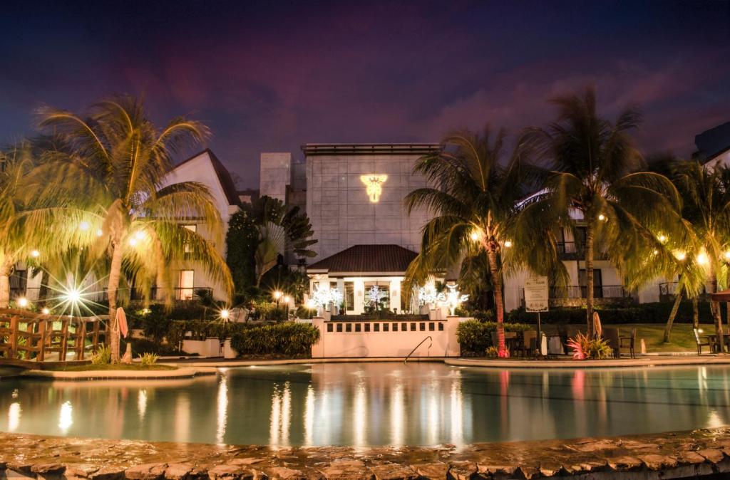 a resort with a swimming pool at night at Thunderbird Resorts - Rizal in Binangonan