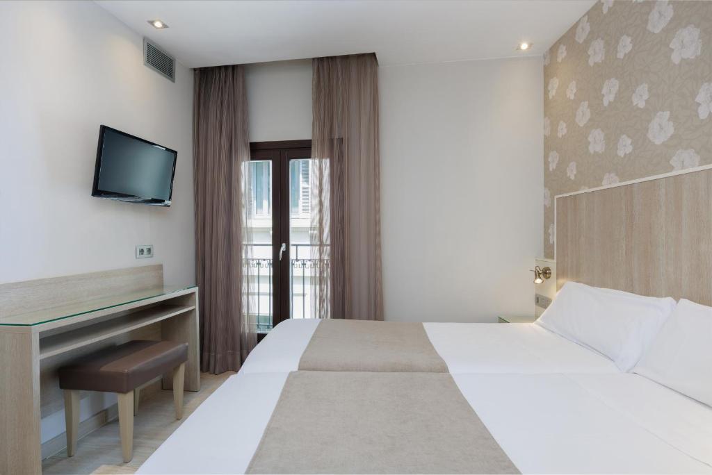 Postel nebo postele na pokoji v ubytování Hotel Santa Marta