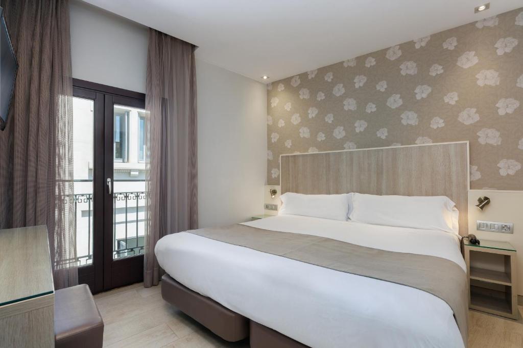 Postel nebo postele na pokoji v ubytování Hotel Santa Marta