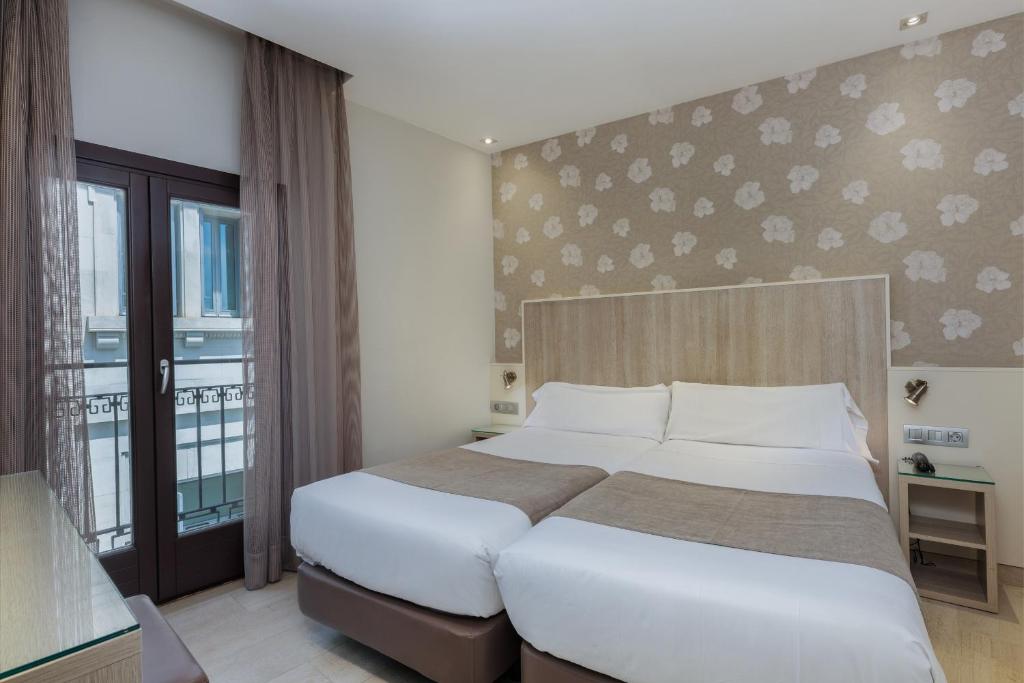 Postel nebo postele na pokoji v ubytování Hotel Santa Marta