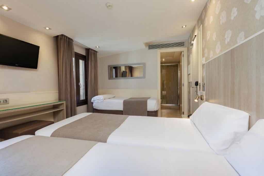 Postel nebo postele na pokoji v ubytování Hotel Santa Marta
