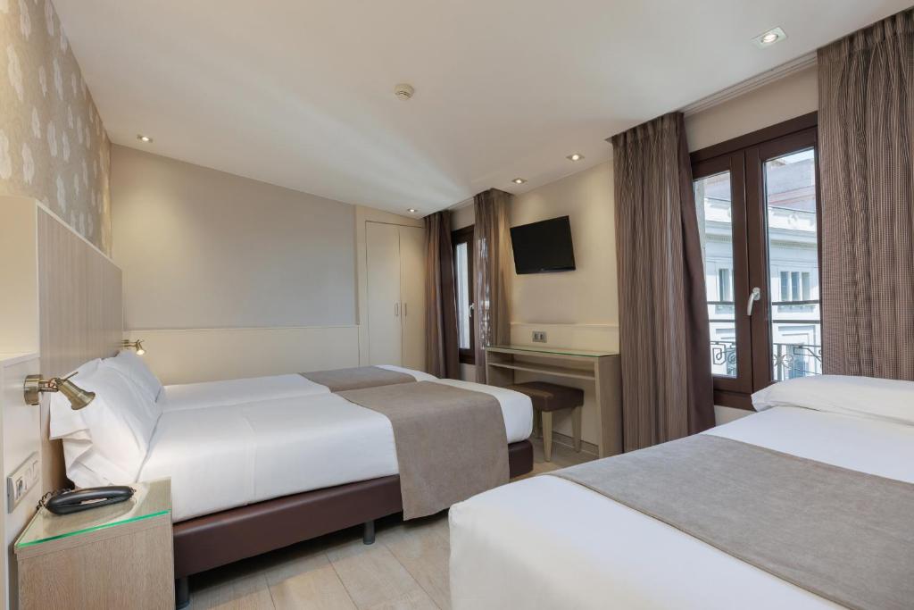 Postel nebo postele na pokoji v ubytování Hotel Santa Marta