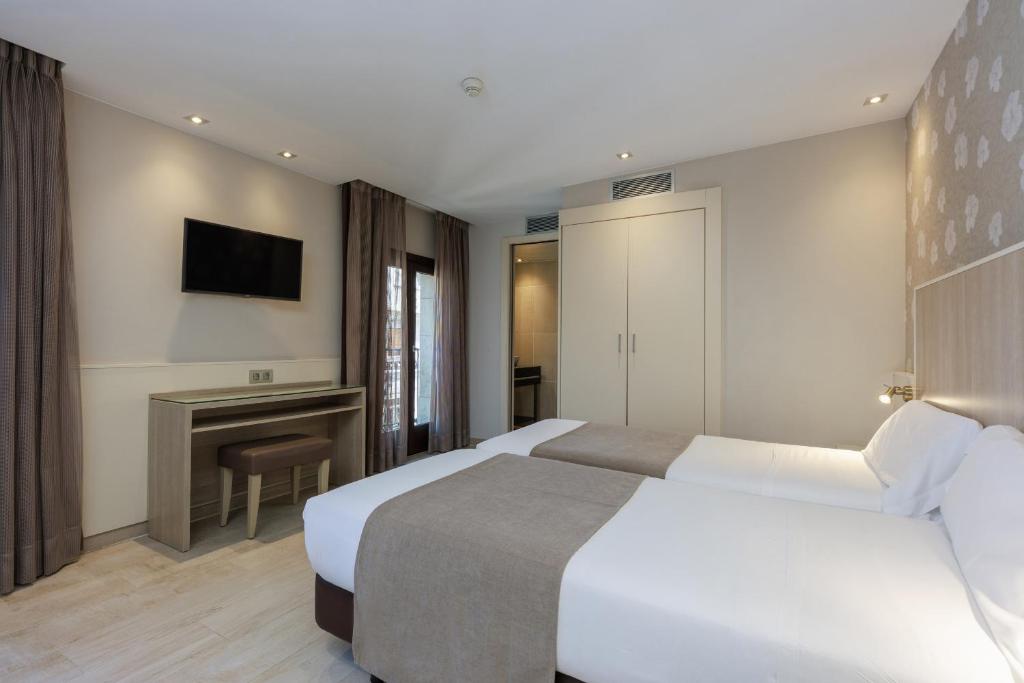 Postel nebo postele na pokoji v ubytování Hotel Santa Marta
