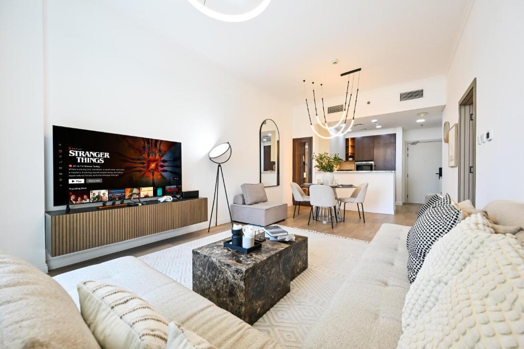 a living room with a couch and a tv at New Renovated Modern 1 Br Dubai Marina in Dubai