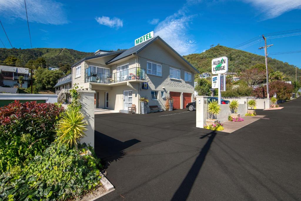 a hotel on a street with a hill in the background at Aldan Lodge in Picton