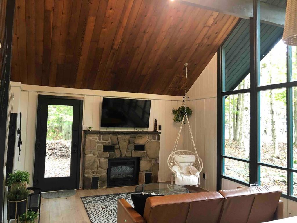 a living room with a couch and a fireplace at Cozy Cottage 1 Block Walk From Lake Naomi - Poconos Pennsylvania Area 2 hours from New York City or Philadelphia - Pets Welcome - Check Minimum Night Requirement in Pocono Pines