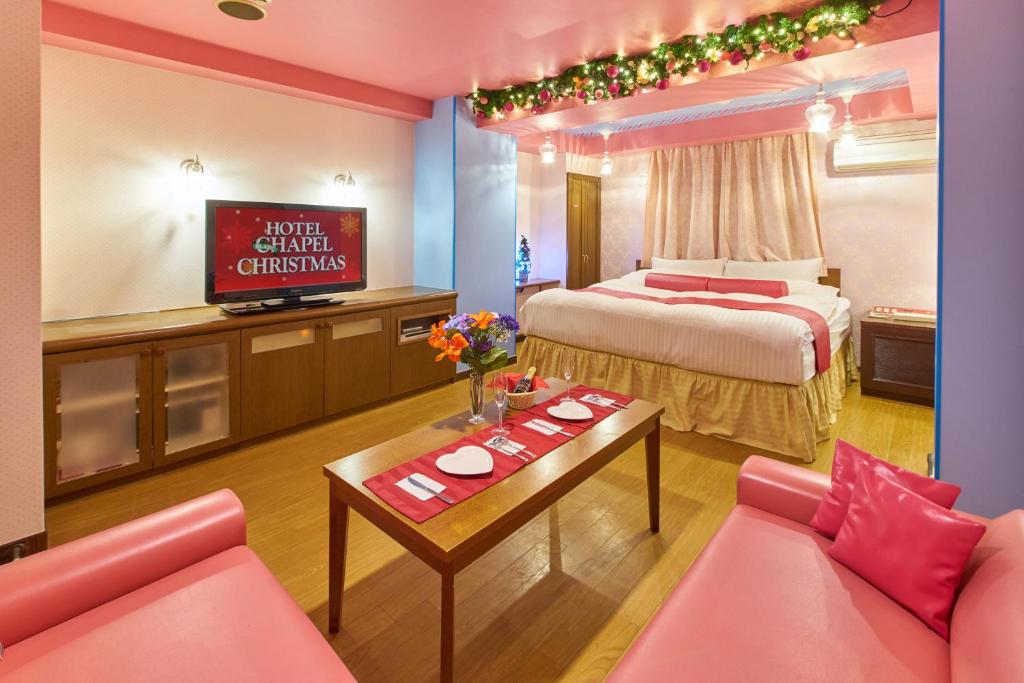 a hotel room with two beds and a television at Hotel Blan Chapel Christmas Narita (Love Hotel) in Narita