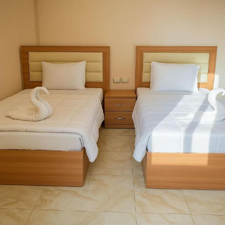 Postel nebo postele na pokoji v ubytování Grand Pyramid View Hotel