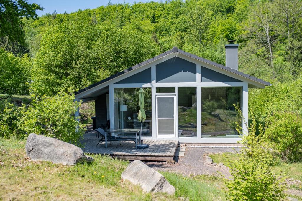 a small house with a porch and a patio at 2 bis 4 Personen F1H3 in Ruhla