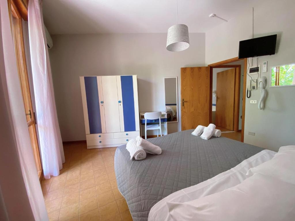 Postel nebo postele na pokoji v ubytování Hotel Residence Ponente