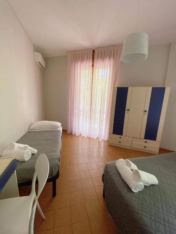 Postel nebo postele na pokoji v ubytování Hotel Residence Ponente