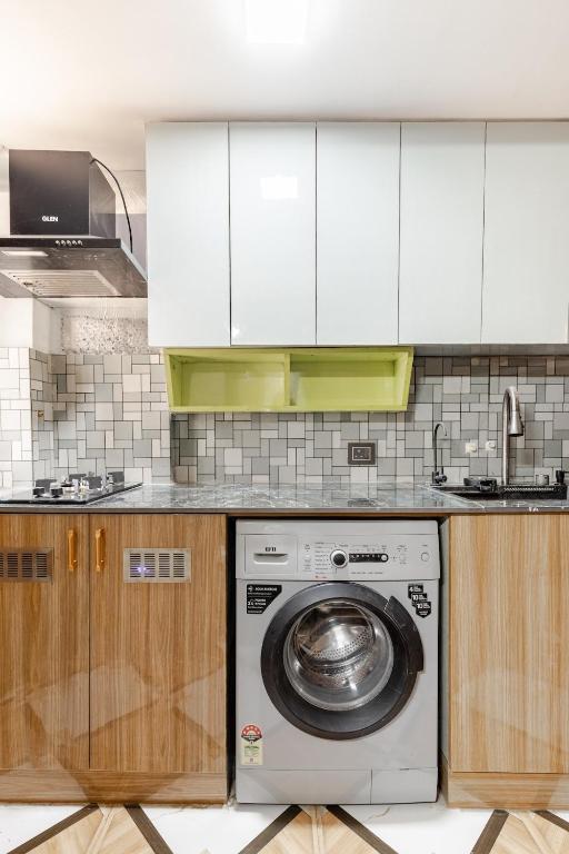 a kitchen with a washing machine and a sink at Super Luxury Independent Studio in Gurgaon