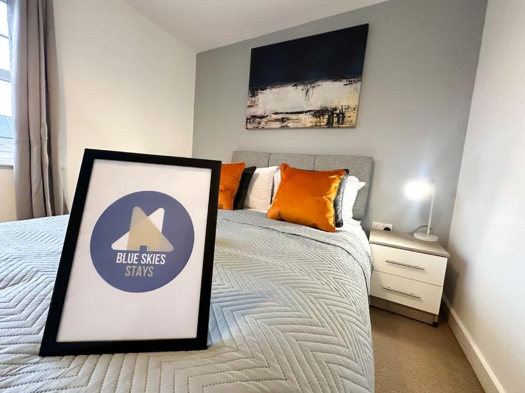 a bedroom with a bed with a sign on it at Edison House by Blue Skies Stays in Stockton-on-Tees