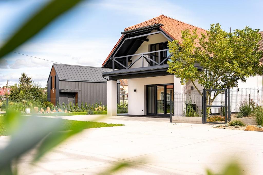 a house with a black roof at ApartHouse 45B in Radomierzyce
