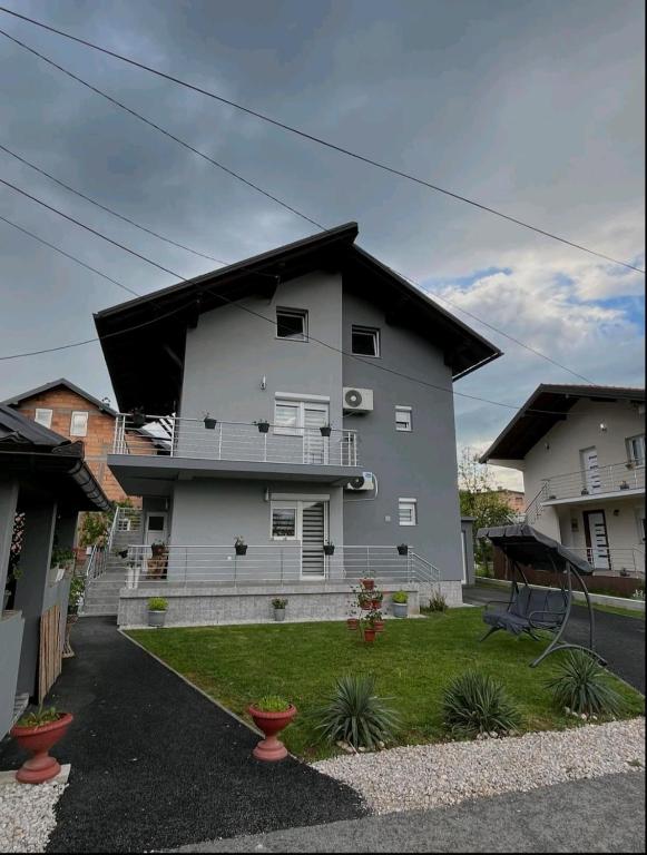 a white house with a black roof at Home in Sarajevo in Doglodi