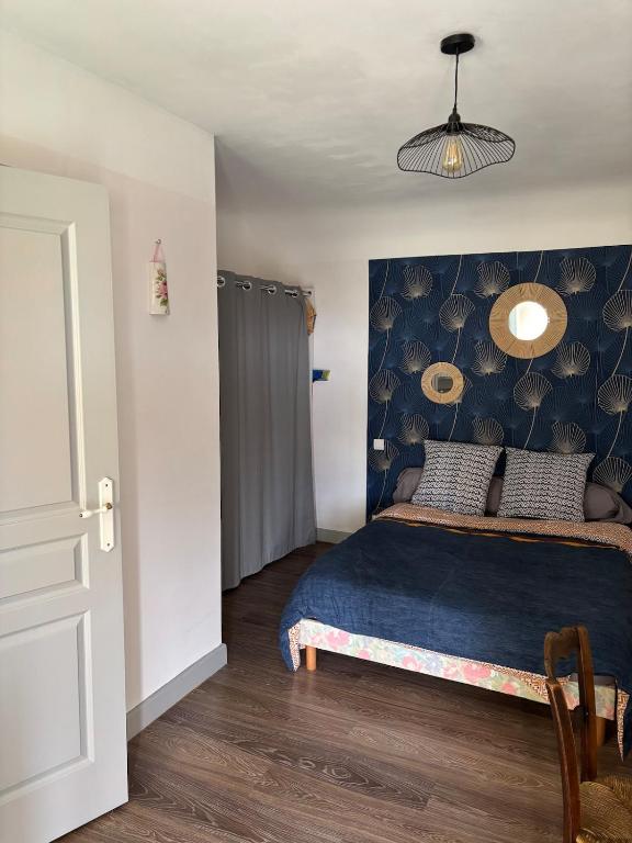 une chambre avec un lit et un mur bleu dans l'établissement Petite chambre indépendante, parking, à Gevrey-Chambertin