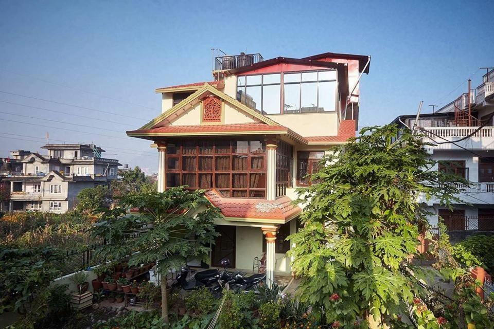 a house on top of a hill with trees at Nagarjun Home Stay in Kathmandu