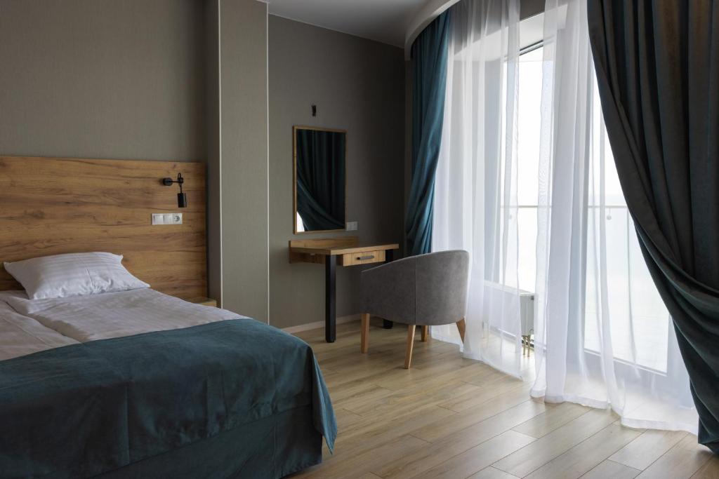 Postel nebo postele na pokoji v ubytování Optima Collection Miramar Chornomorsk