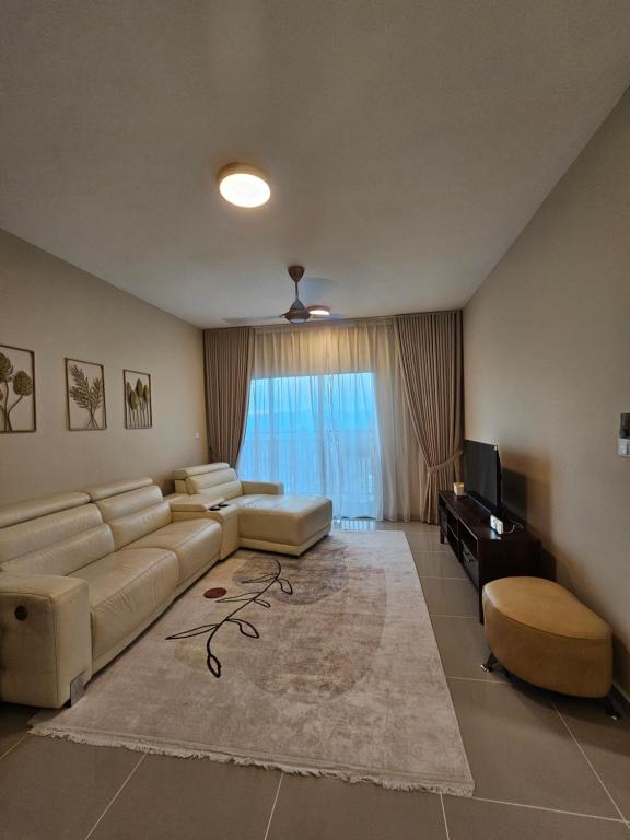 a large living room with a couch and a television at Ruhani Guesthouse KL Setapak Muji Style in Kuala Lumpur