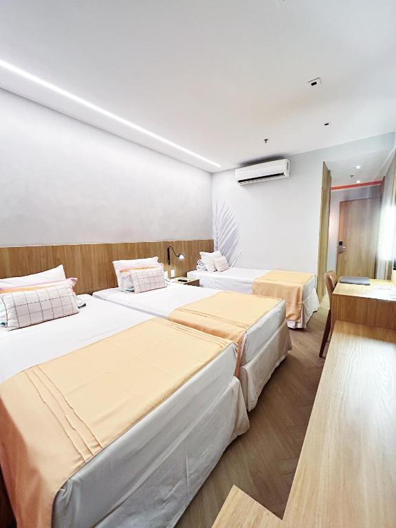 a hotel room with two beds in a room at Mar Ipanema Hotel in Rio de Janeiro