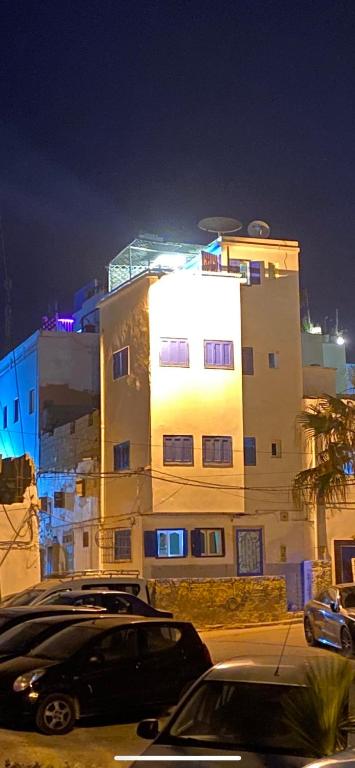 a building with a car parked in front of it at Taghazout studio & rooftop in Taghazout