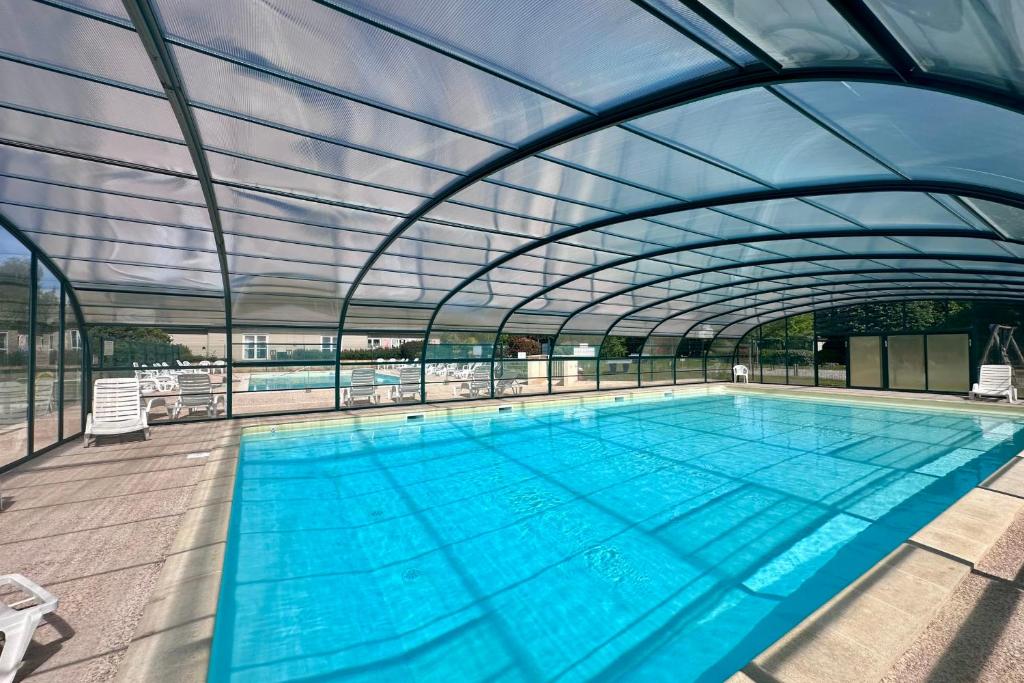 una grande piscina con tetto retrattile di Chalet de 4 pers - Lac de Miel à 500m - Beynat - Parking Piscine a Beynat