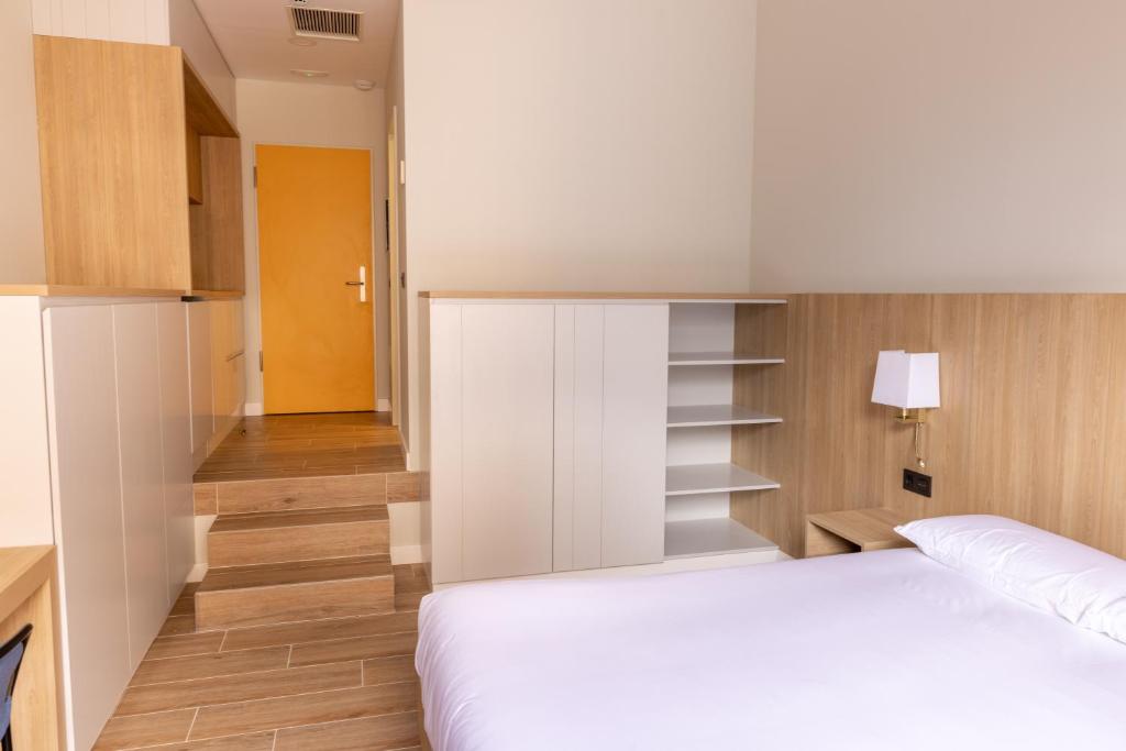 a bedroom with a white bed and wooden floors at E4 - Estudio La Orotava in La Orotava