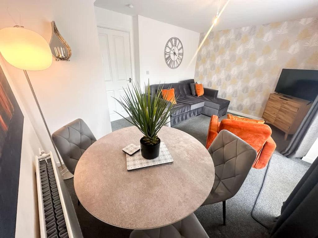 a living room with a table and a couch at Aristotle House by Blue Skies Stays in Stockton-on-Tees