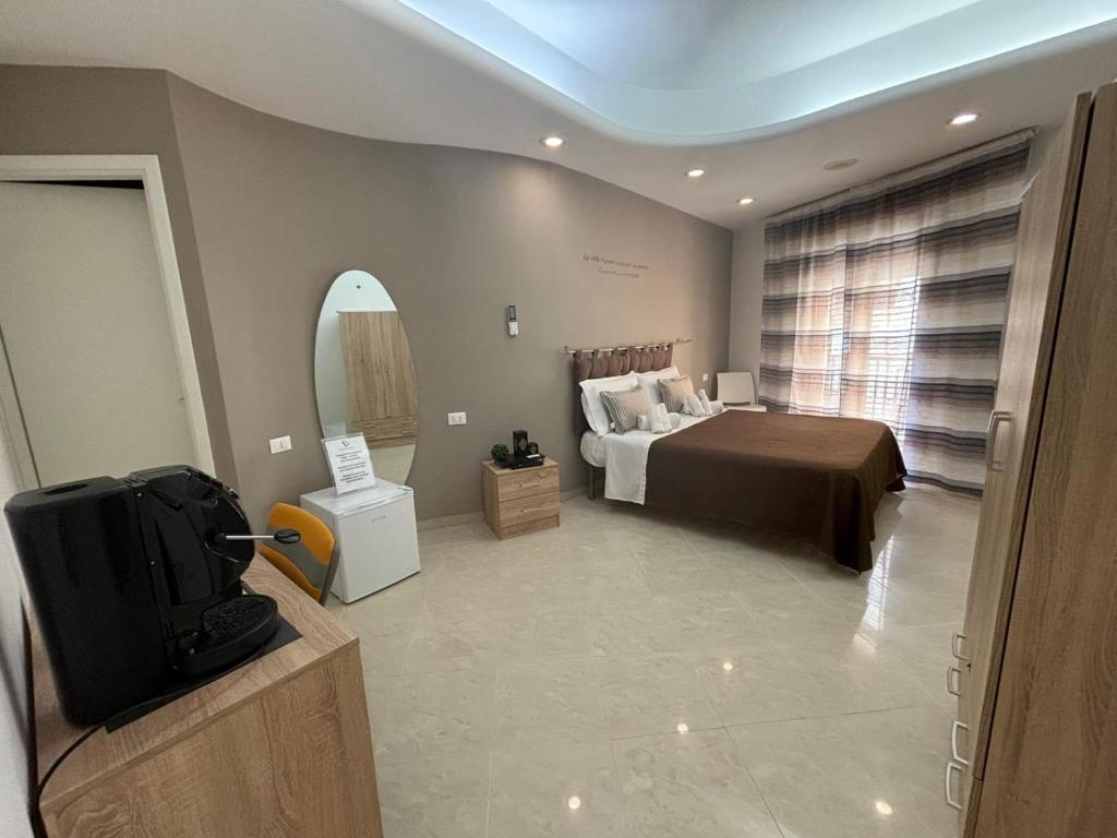 a bedroom with a large bed and a mirror at SOGNO D'ESTATE 2 in Mazara del Vallo