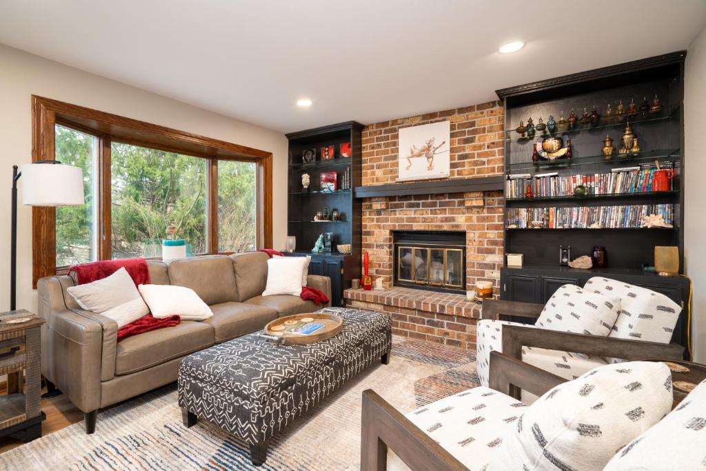 a living room with a couch and a fireplace at Creekside Lodge in Minnetonka