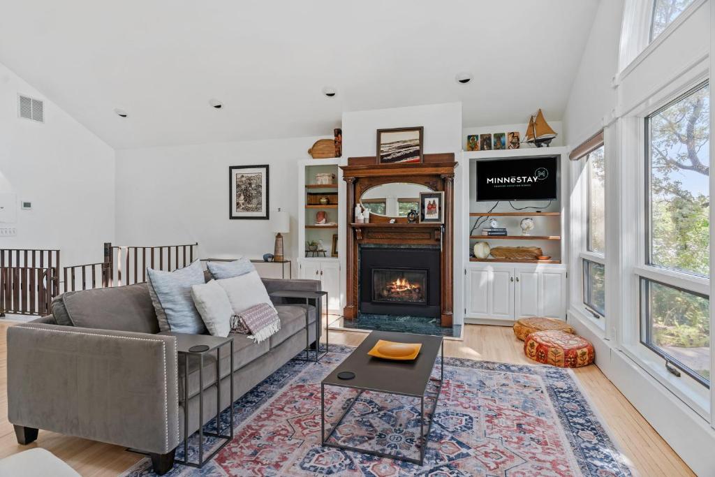 a living room with a couch and a fireplace at Villa de Lago in Champlin