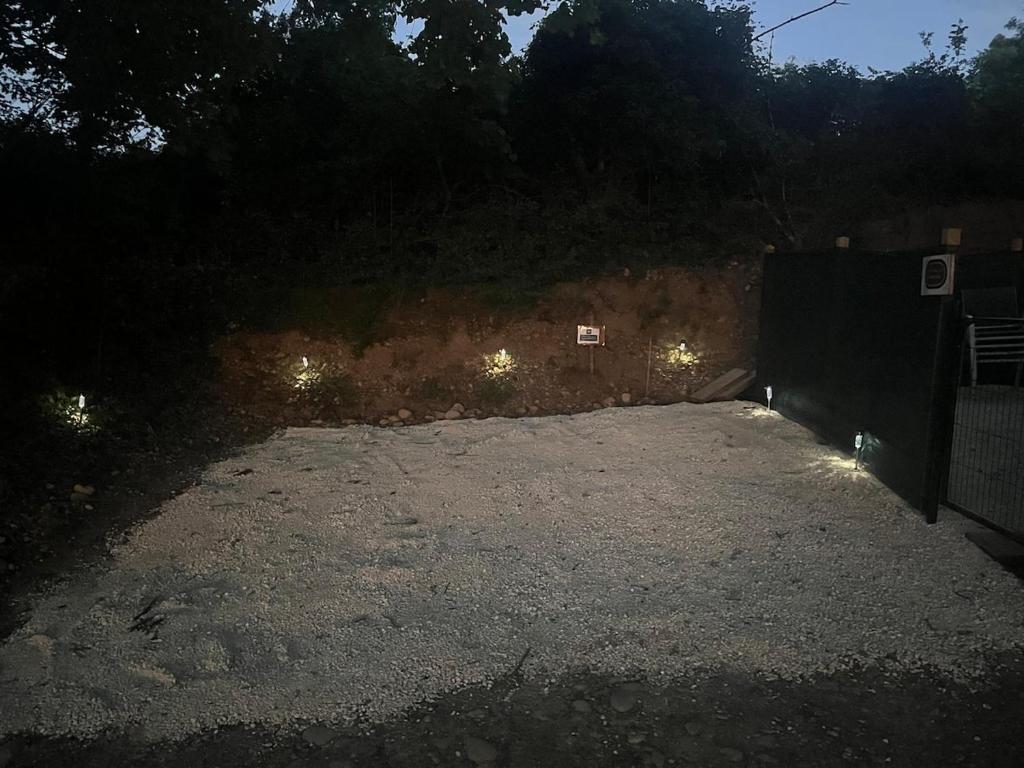 an empty parking lot with lights in the dark at L'écrin du Bonheur in Saint-Bardoux