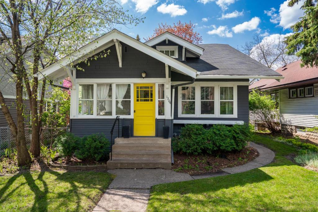 a house with a yellow door at Grand Residence in Saint Paul