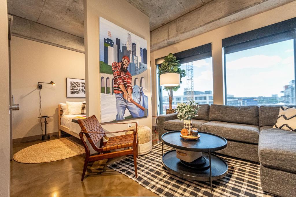 a living room with a couch and a table at Sable 702 - Alcove in Minneapolis