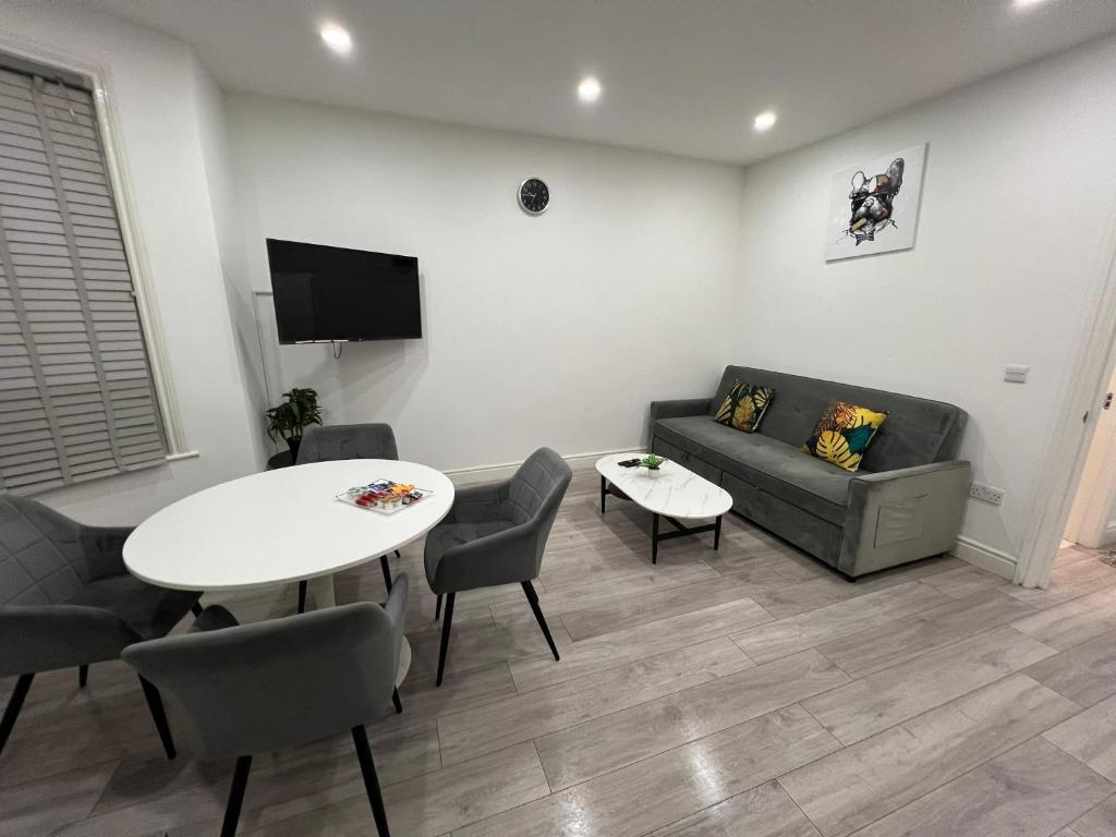 a living room with a couch and a table at F4 Luxury Stays One bed apartment with Parking in Ilford