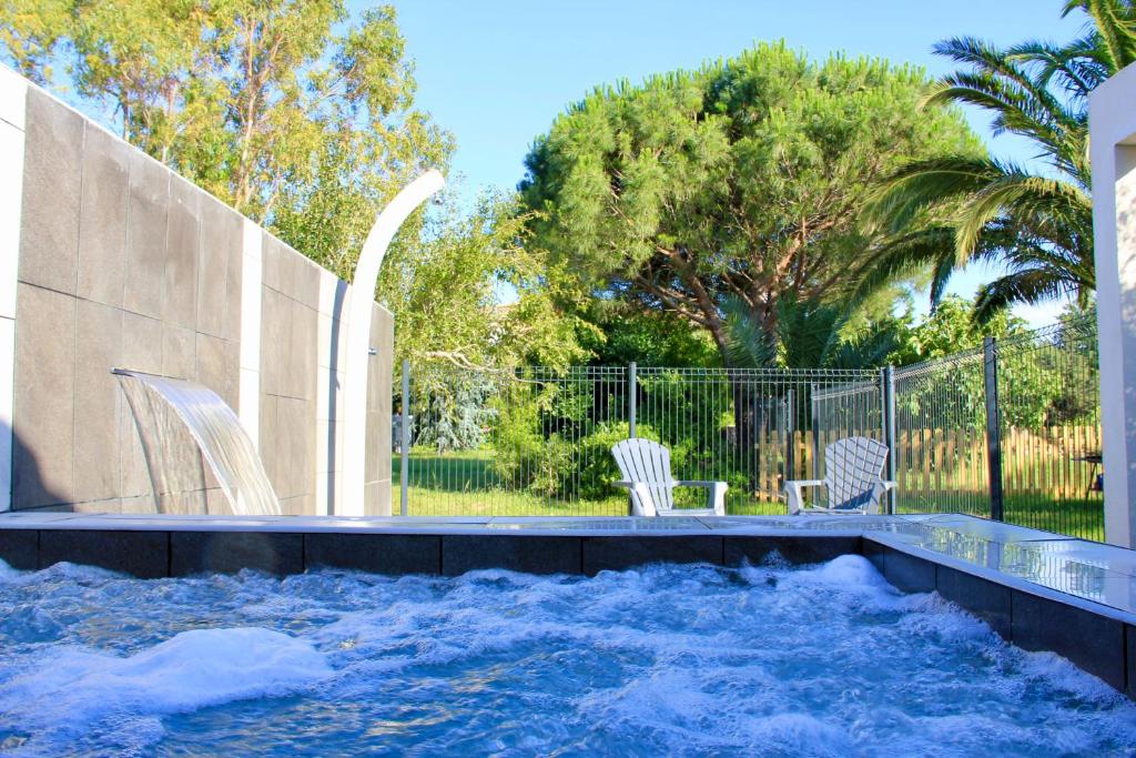a swimming pool with a water slide at Mas de l Aire in Corneilla-del-Vercol