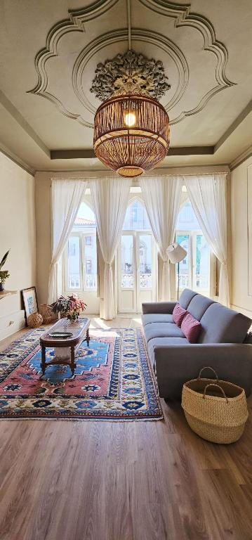 a living room with a couch and a chandelier at Alma House - Caminha in Caminha
