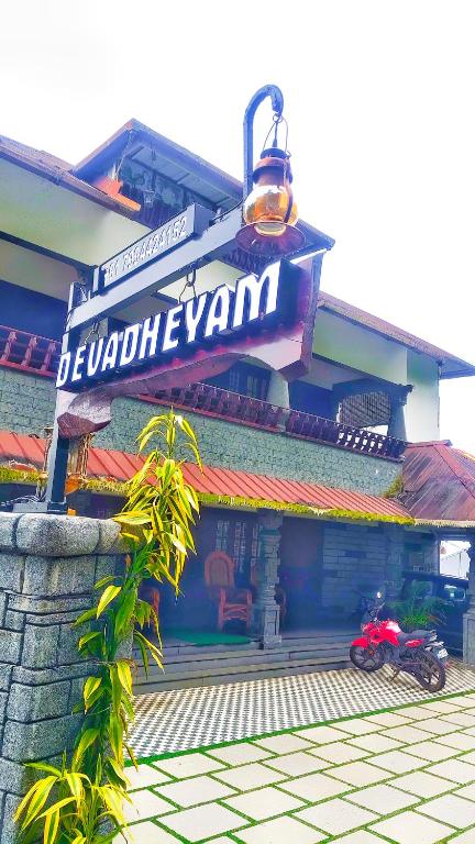 a red motorcycle parked in front of a restaurant at DevaDheyam Homestay in Munnar