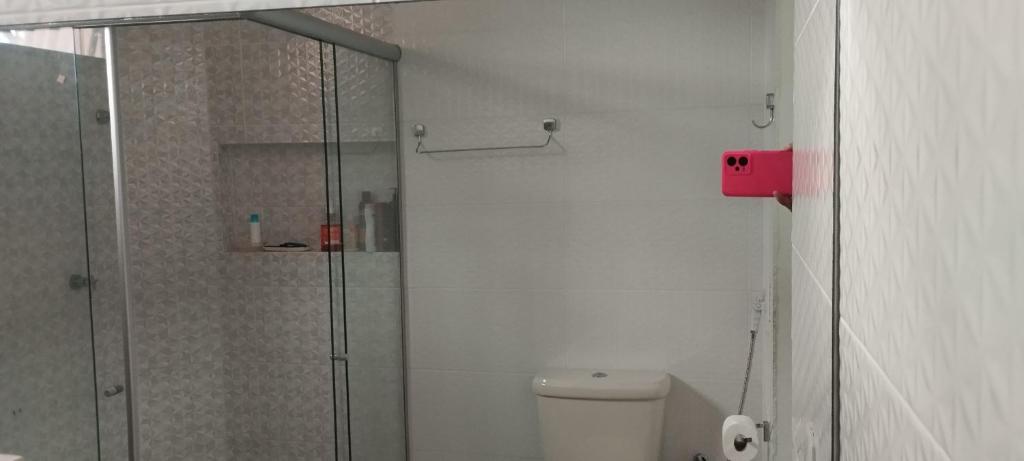 a bathroom with a toilet and a glass shower at Casa para COP 30 in Belém