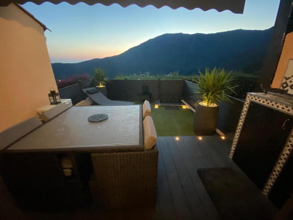 a balcony with a table and a view of a mountain at Superb studio for 4 people in Le Lavandou