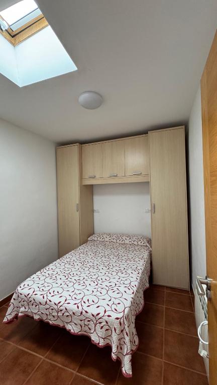 A bed or beds in a room at Apartamentos San Guillermo