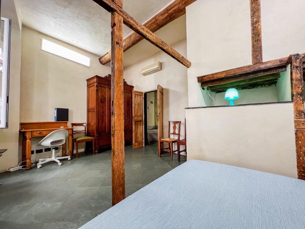 a room with a bed and a desk and chairs at lovingenoa Iter - Nos in Genoa