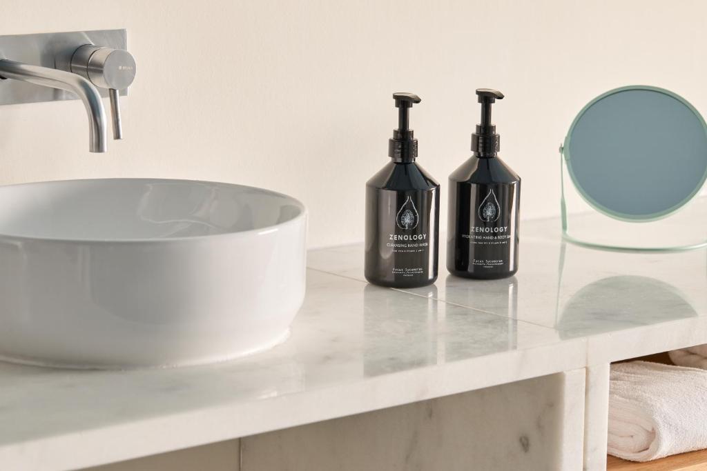 two bottles of wine sitting on a counter next to a sink at Hotel Indigo Albufeira by IHG in Albufeira