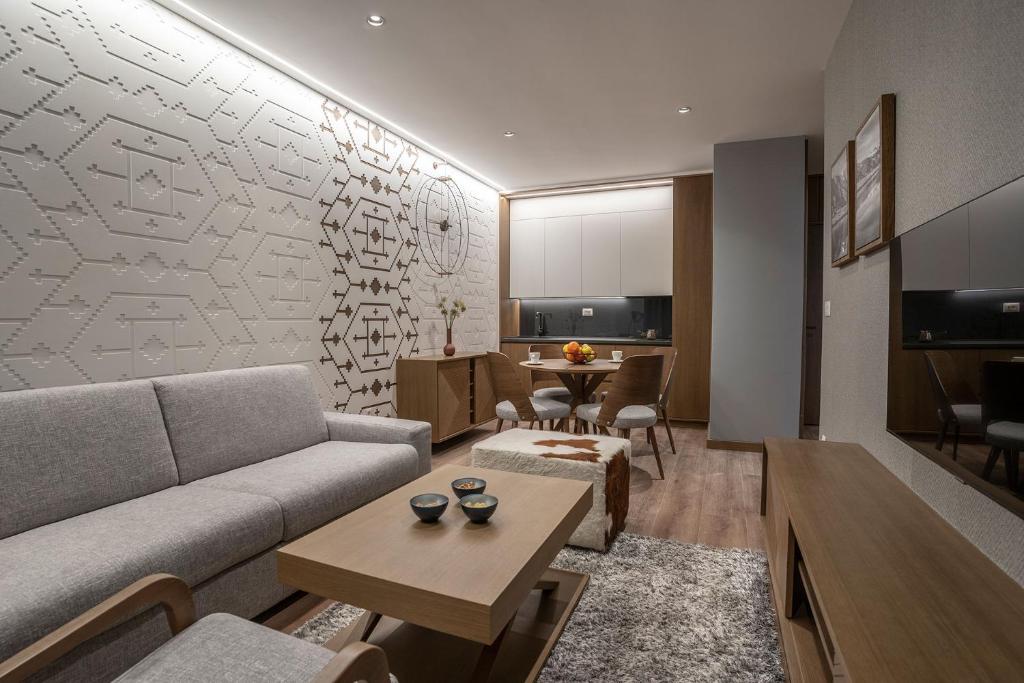 a living room with a couch and a table at Zlatibor Lux Spa Apartments in Zlatibor
